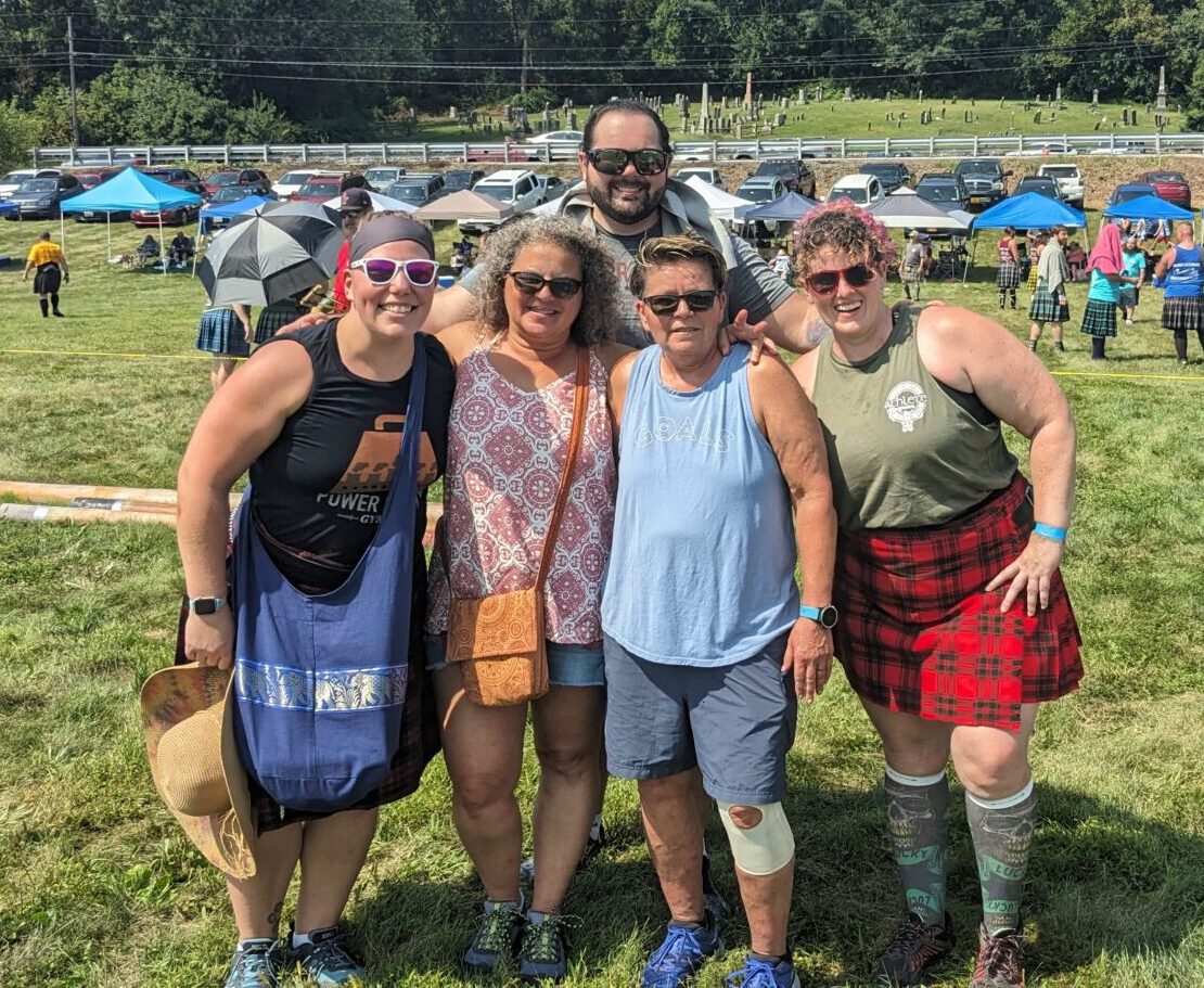 A small group of Power Plant Gym members post outside at a Highland Games in Pennsylvania.